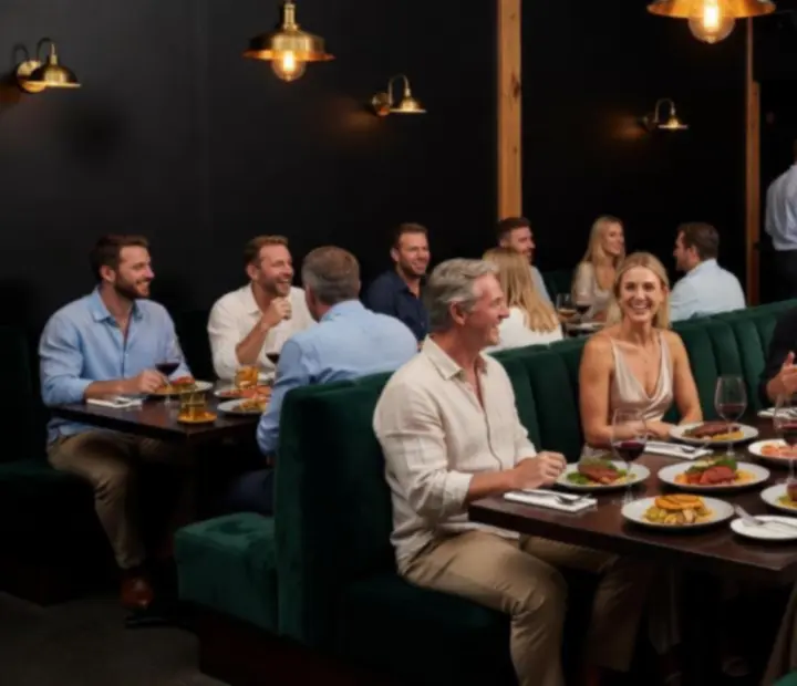 Guests dining in a mood-lit bistro during an evening event at The Final Fold Feast